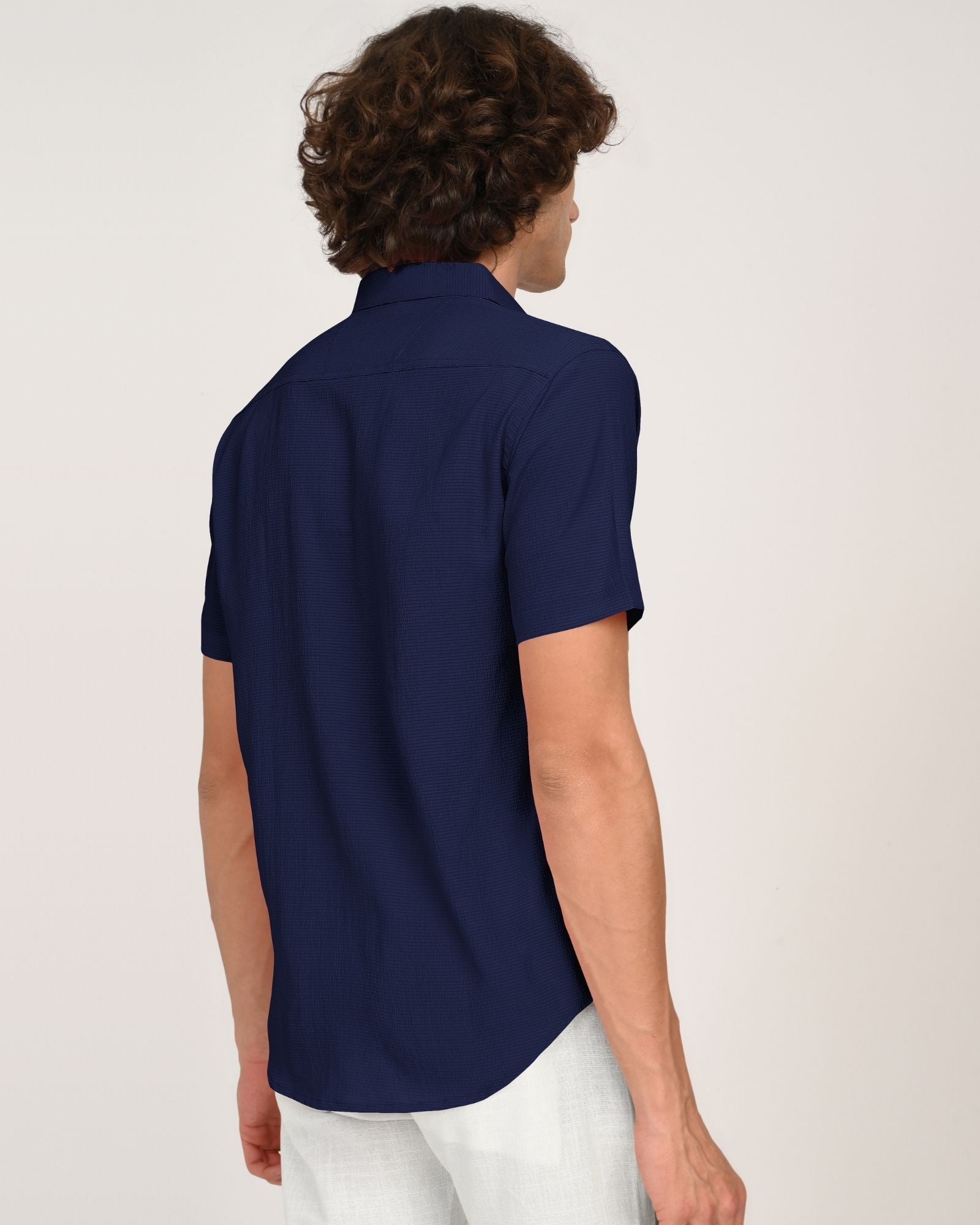 Back view of navy textured short-sleeve button-up shirt