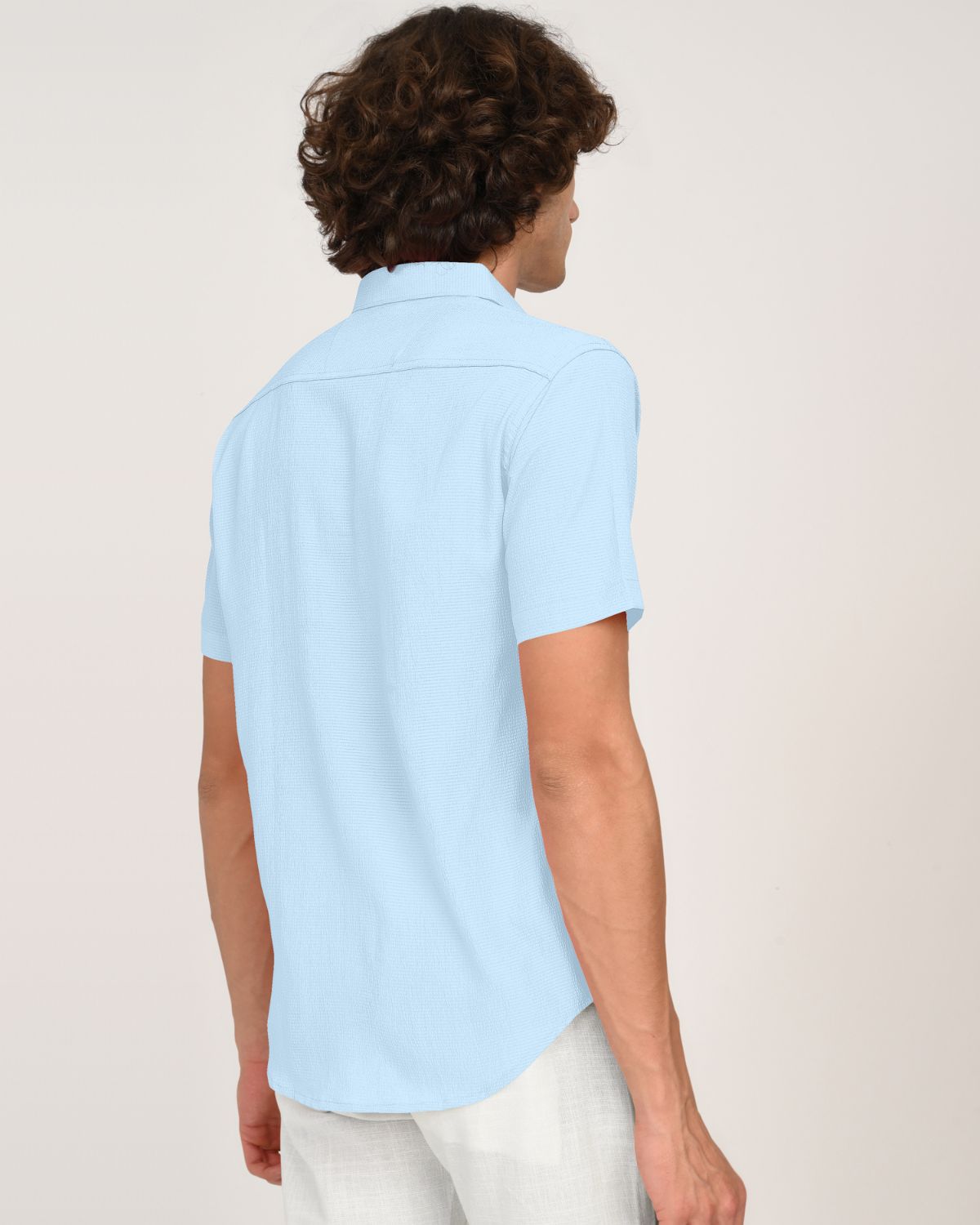 Back view of sky blue crinkle textured short sleeve shirt