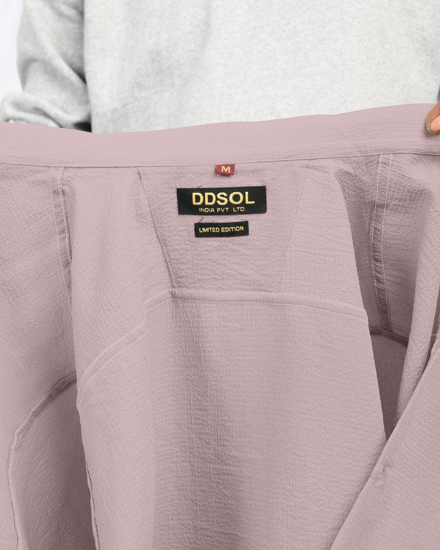 Close-up label of dusty mauve crinkle textured shirt