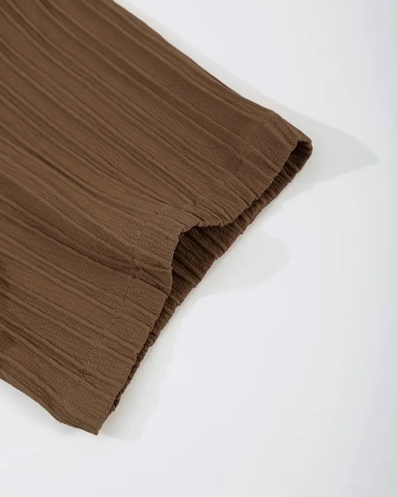 Crinkled sleeve edge showing fabric texture in brown set