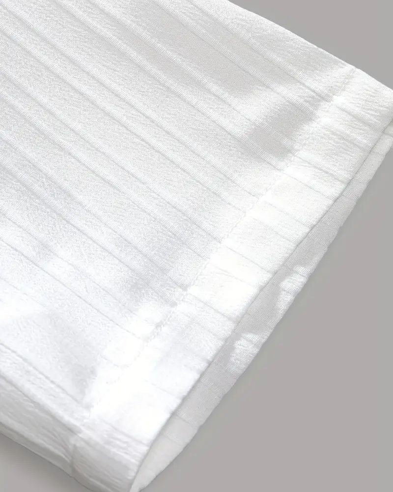 Detailed close-up of crinkle hem on white cane lounge pants for men