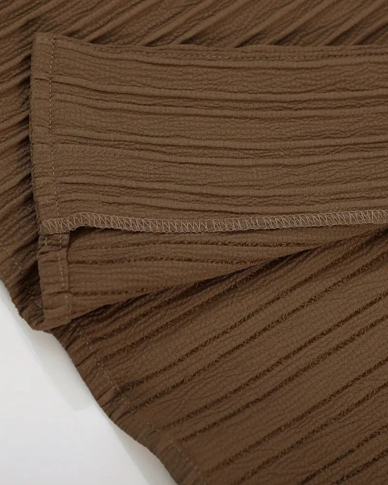 Detailed stitching on sleeve hem of brown shirt