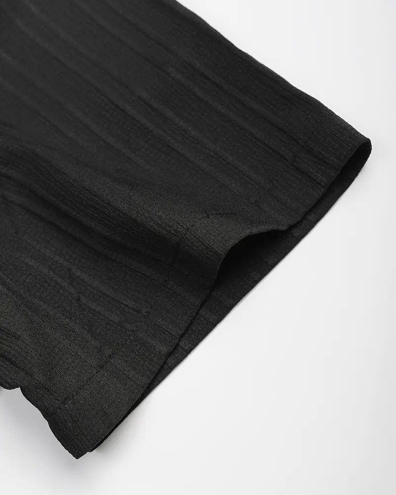 Detailed view of crinkle hem on black cane lounge pants for men