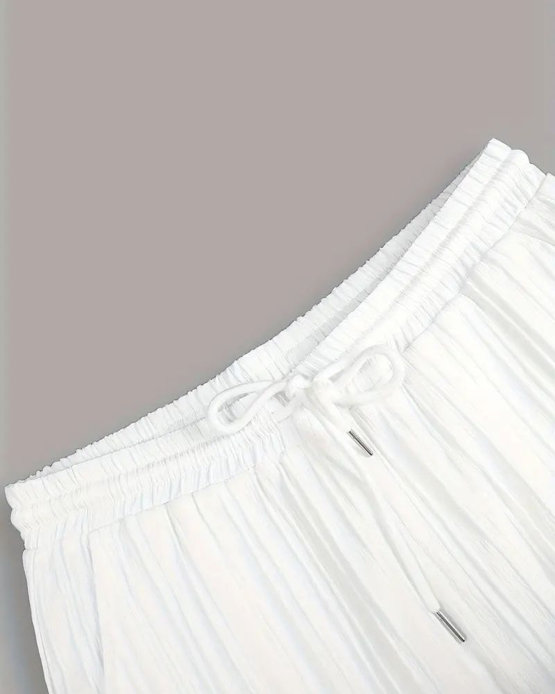Elastic waistband with white drawstring on ivory pleated trousers