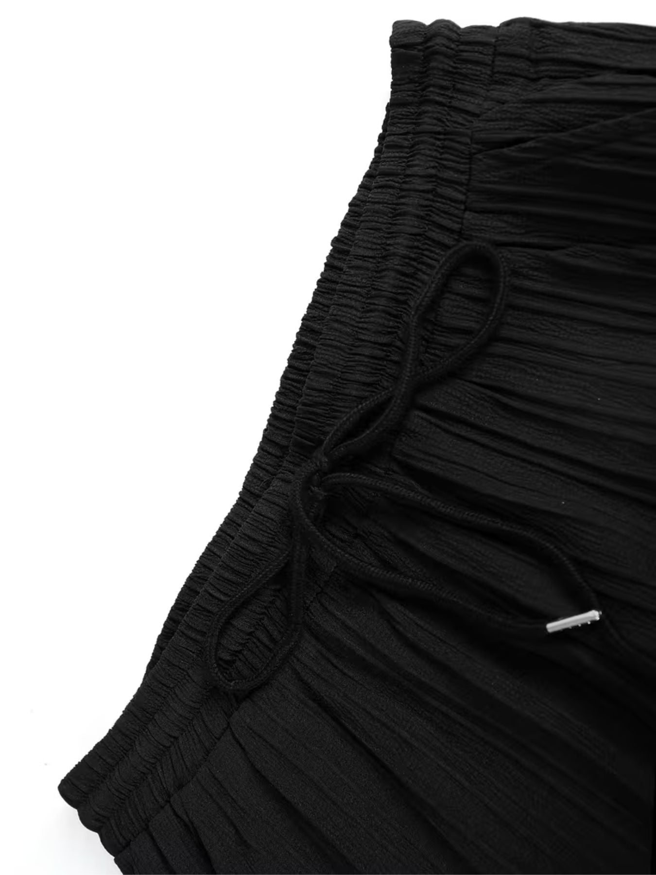 Elasticated waistband of black cord set pants with adjustable drawstring for comfortable fit