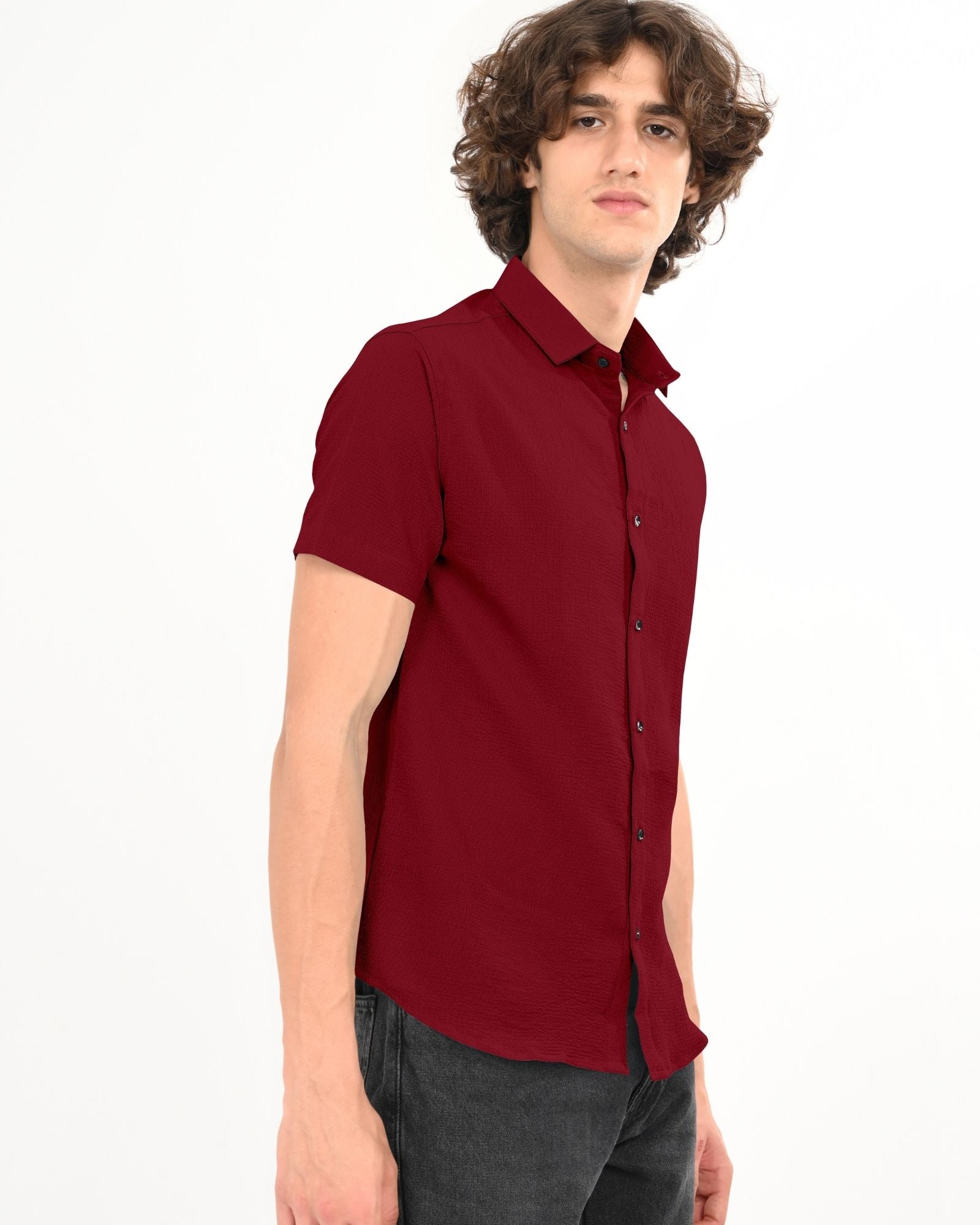 Man posing in a crimson red short sleeve textured shirt with short sleeves and a casual fit
