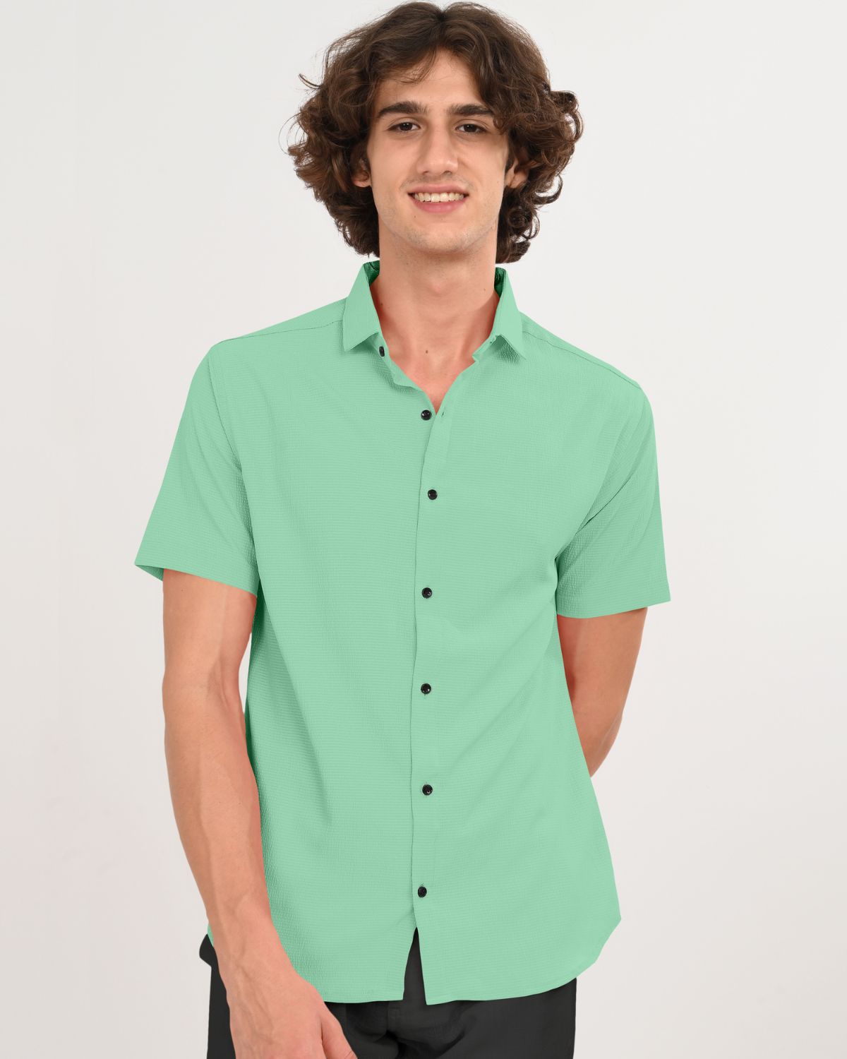 Man smiling in mint green short sleeve button-up shirt