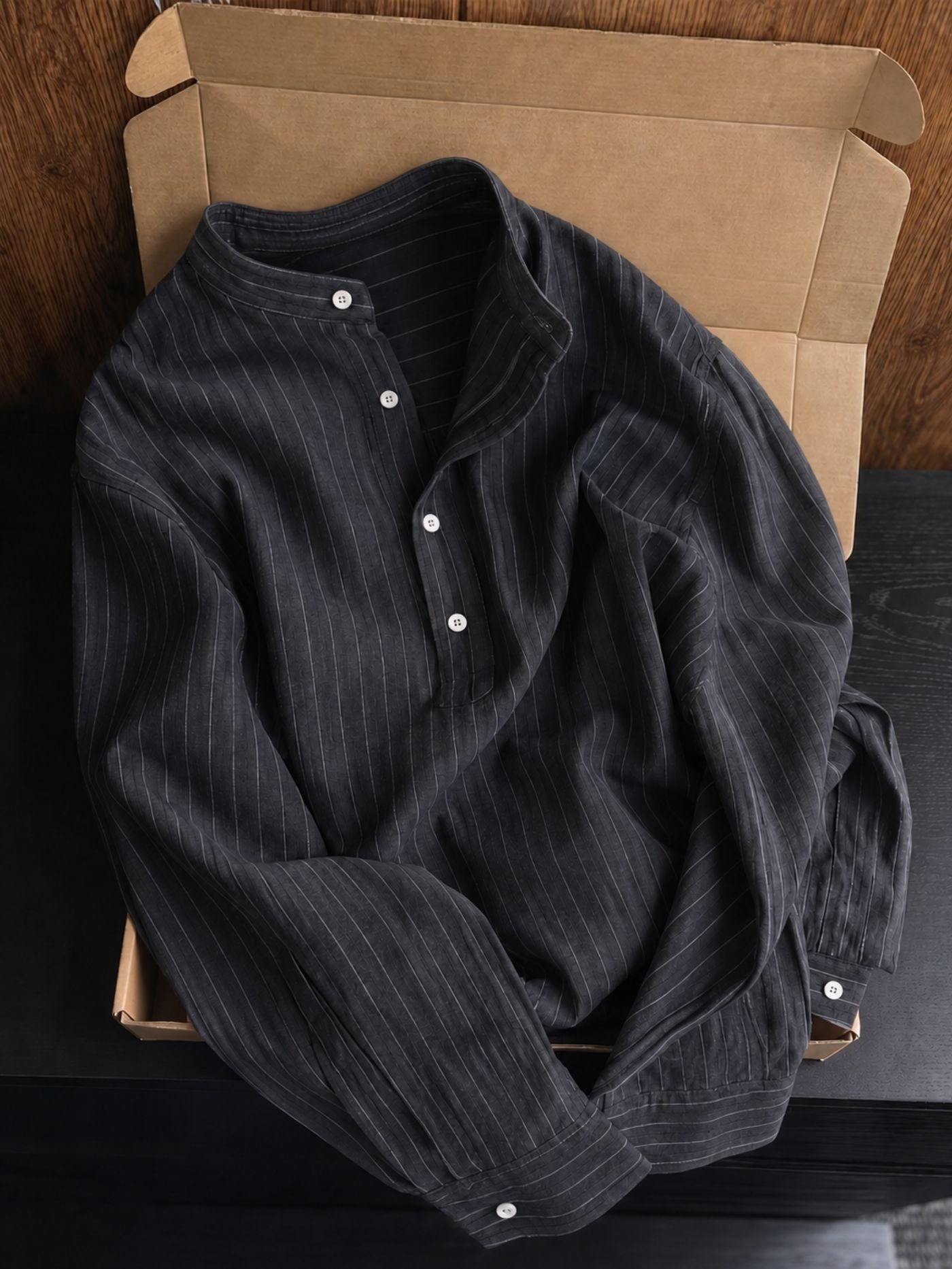 Charcoal pinstripe casual shirt featuring a half-button placket and band collar.