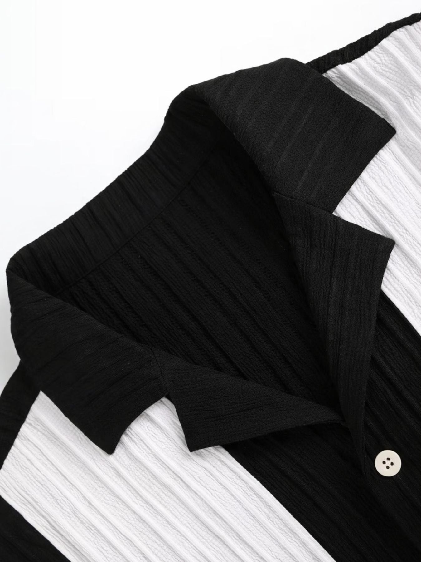Open collar black and white shirt with button front and textured fabric detailing