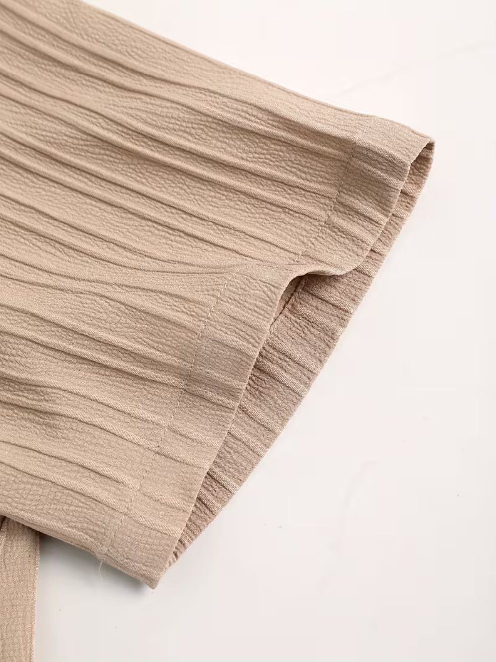 Short sleeve detail of premium breathable sand color street shirt with smooth textured fabric