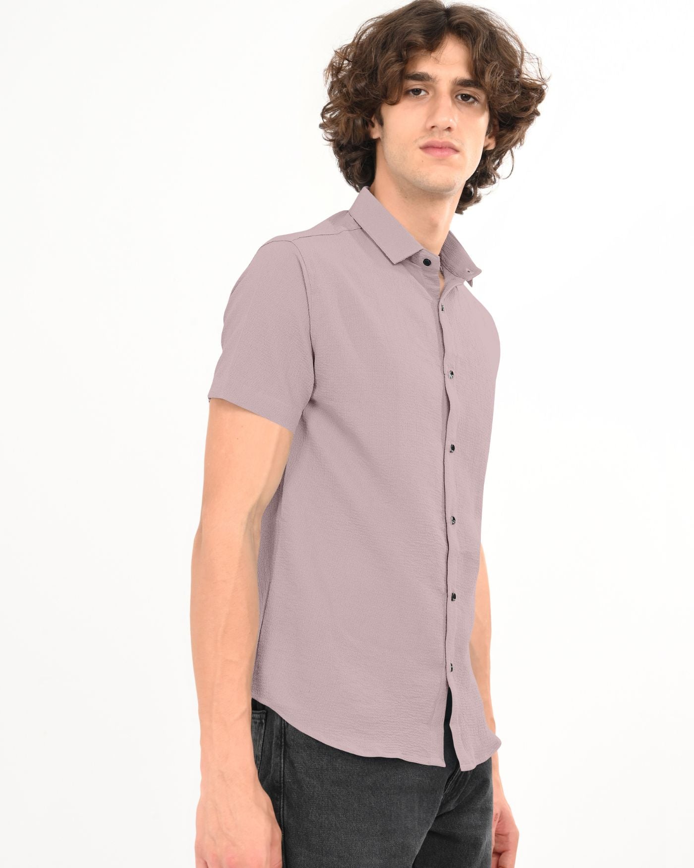 Side view of man in dusty mauve textured short sleeve shirt