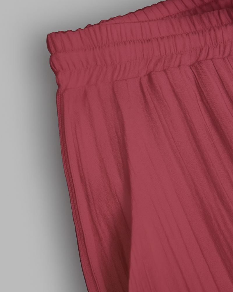 Close-up of red pants with an elastic waistband on a gray background