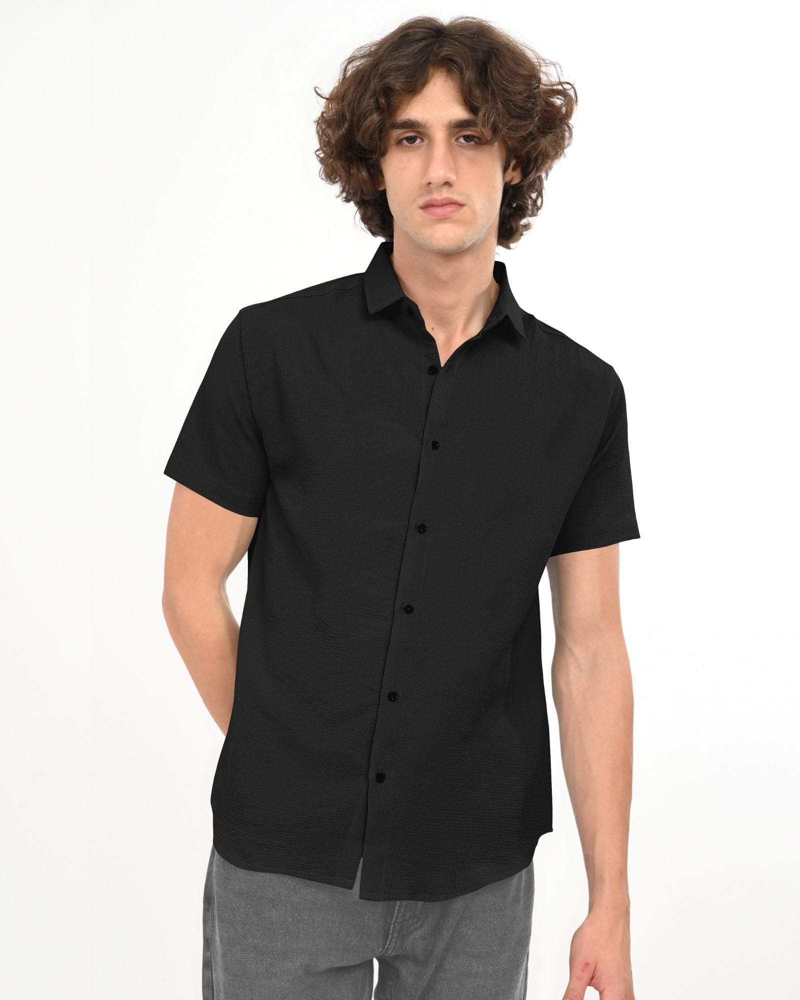 Black textured shirt on hanger, highlighting collar and buttons