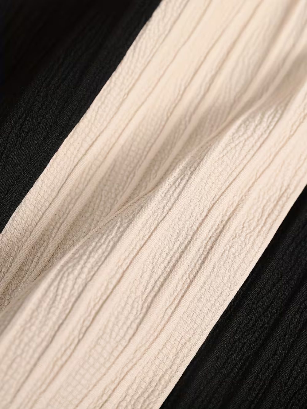 Close up of breathable textured fabric in noir sand shirt