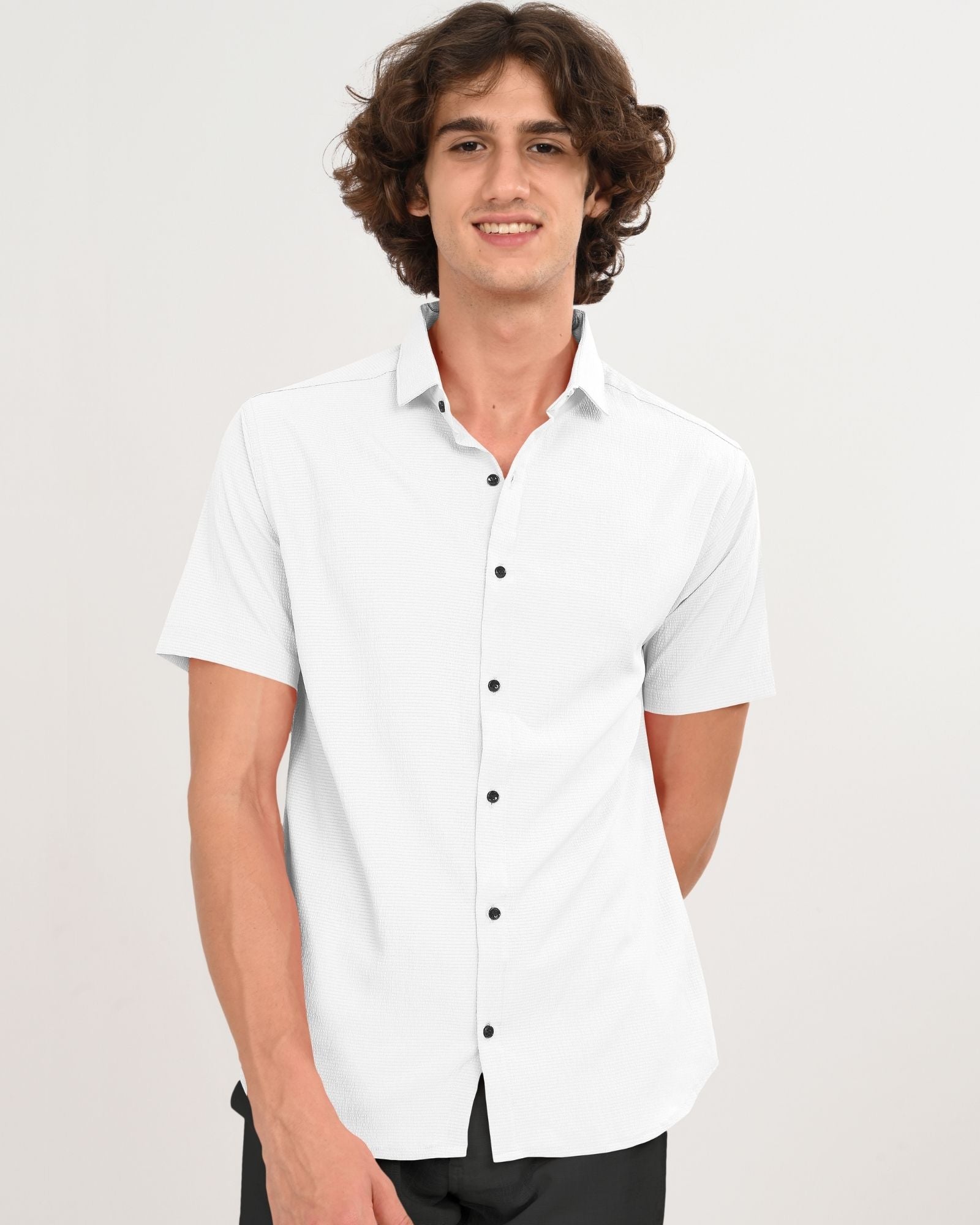 Front view of man wearing classic white short sleeve button-down shirt with black buttons