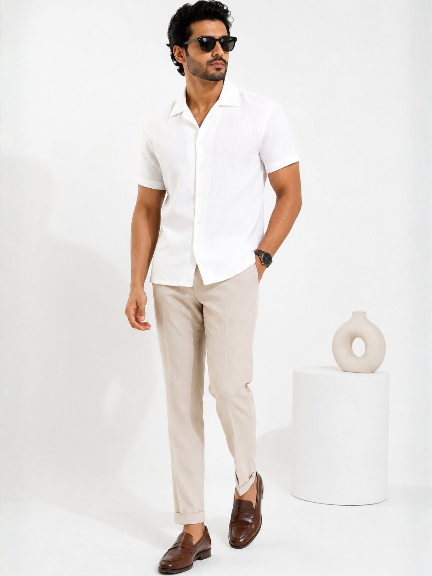 Male model styling the Lucent Pure White Cuban Collar Shirt with beige trousers