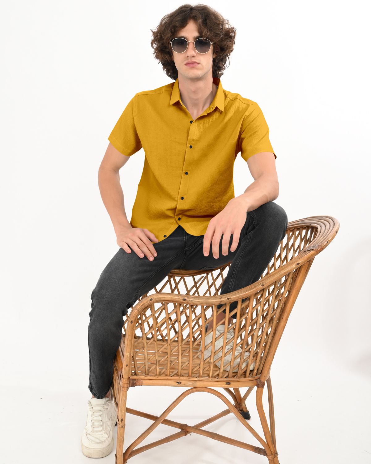 Man wearing golden mustard crinkle short sleeve shirt sitting on chair