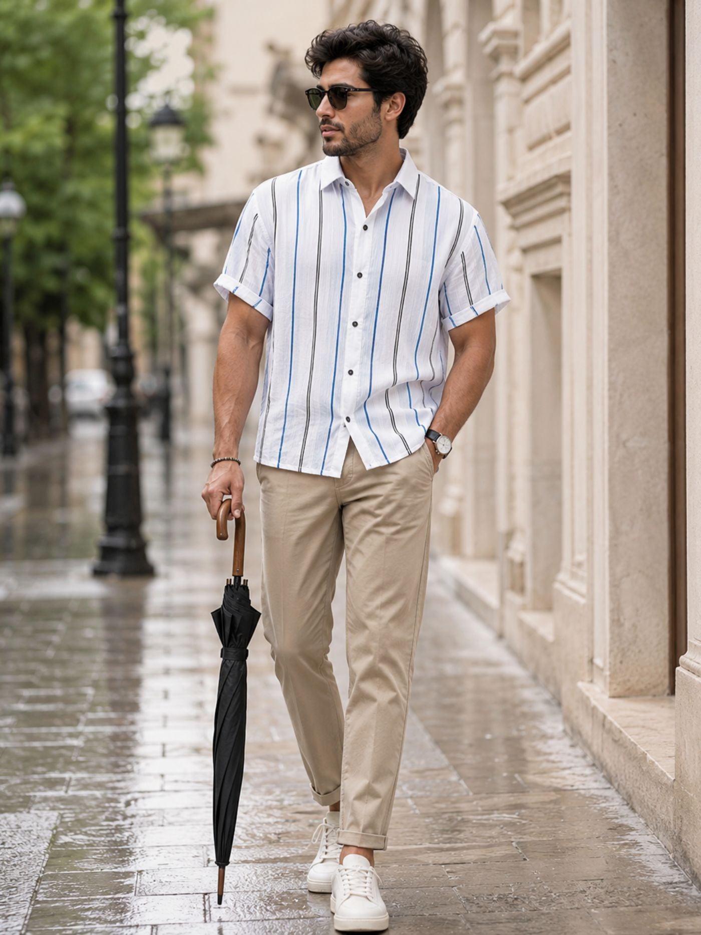Men's white vertical stripe Cuban collar short sleeve casual shirt paired with beige chinos for a smart casual summer look.