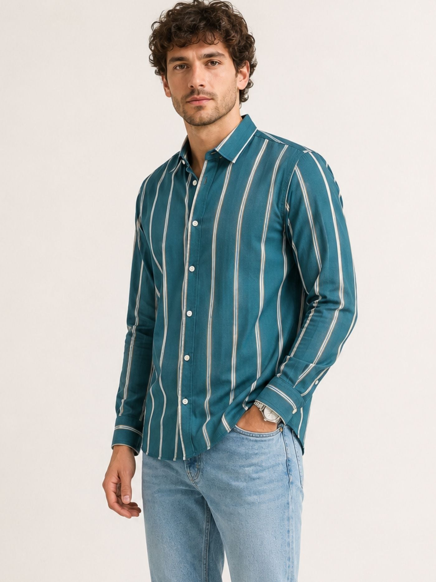 Model wearing Aeron deep teal striped shirt with light-wash denim