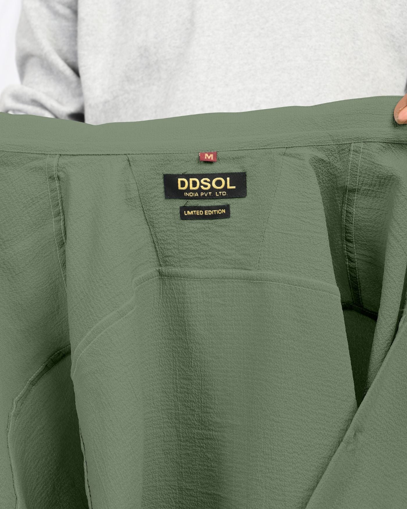 Olive green crinkle textured shirt close-up label view