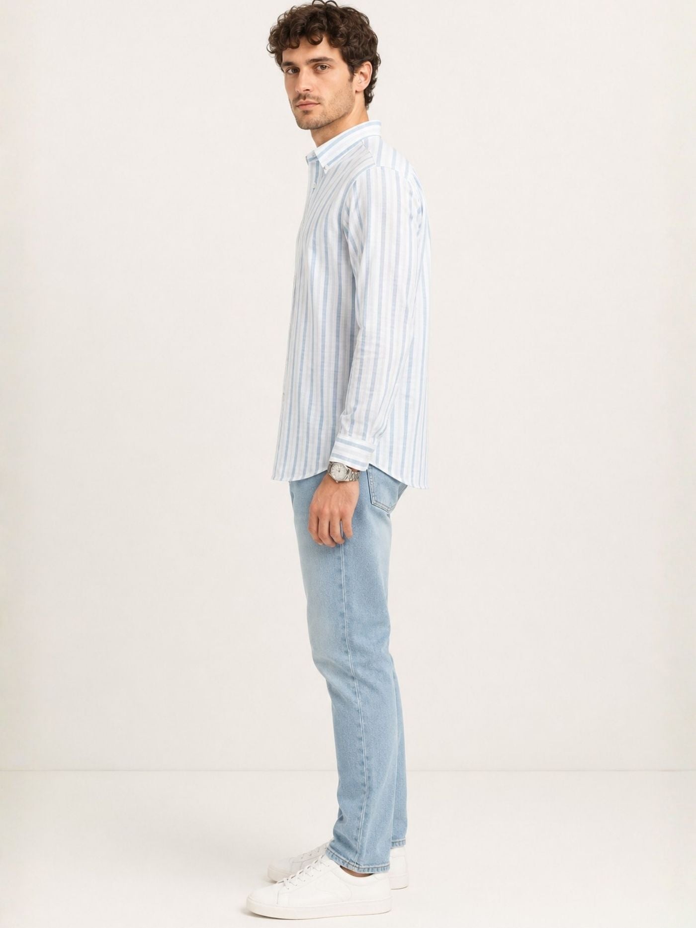 Side profile of Caelum sky blue striped full-sleeve shirt styled with jeans