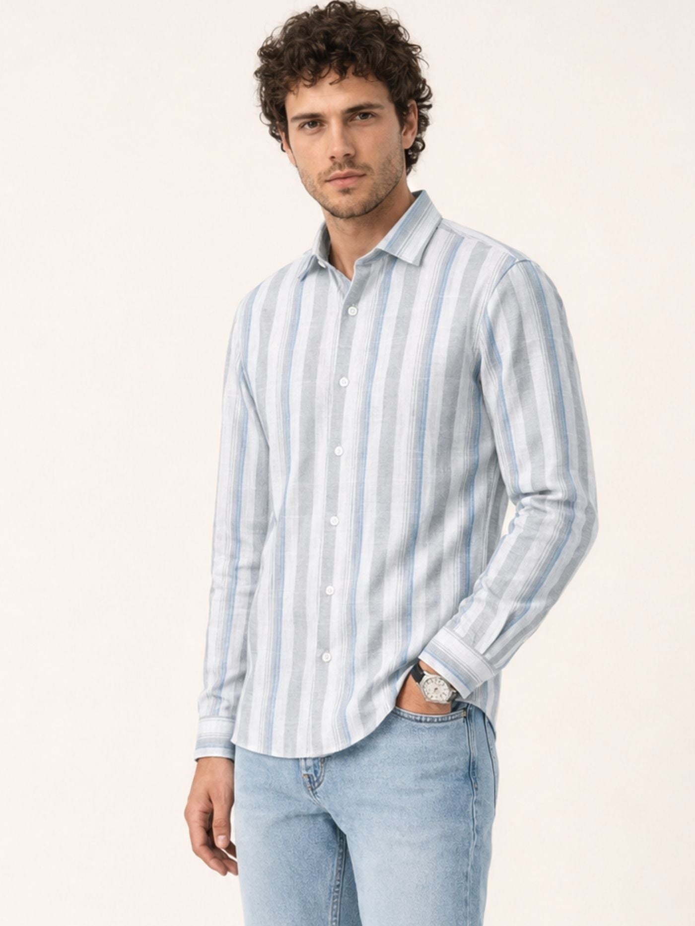 model in Caelum sky blue striped shirt with rolled sleeves and light blue jeans