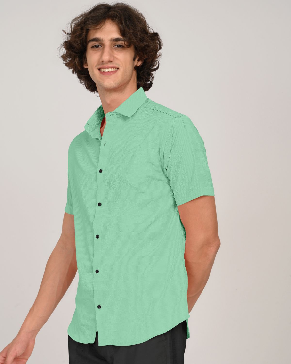 mint green textured short sleeve shirt on model